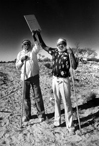 DECEMBER 18, 1984: (L-R) Aboriginal tribal elders Tommy Queama and Jack Baker hold the Maralinga land grant documents above their heads. The deeds give them 8 percent of SA. The local aborigines had been forced off the land in 1951 when Britain wanted the land for atomic (nuclear) weapons testing. (Photo by Milton Wordley / Newspix) Contact Email: www.newspix.com.au Contact Web URL: newspix@newsltd.com.au Contact Email: www.newspix.com.au